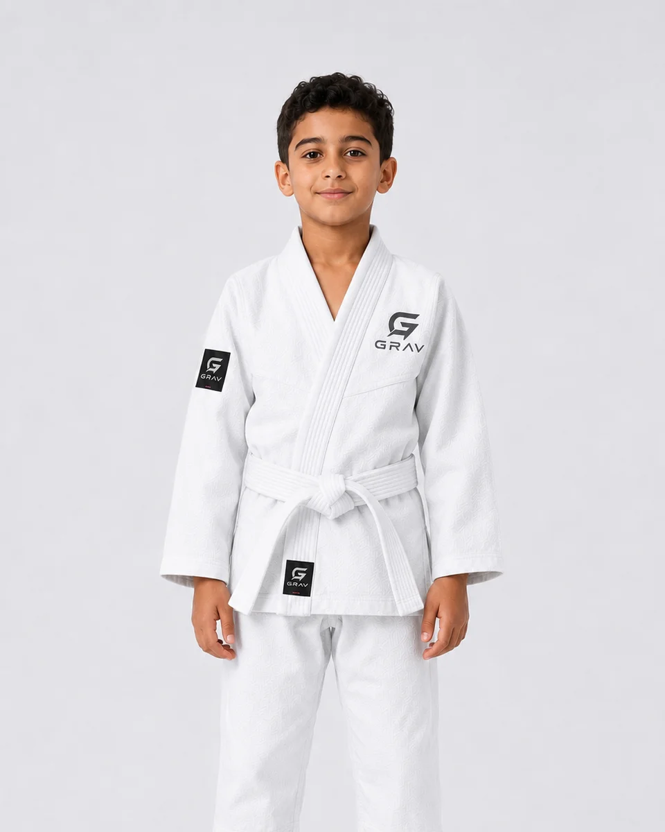 A child wearing a GRAV youth BJJ gi with a grey belt